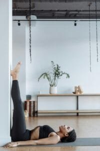 Woman practicing a relaxing yoga pose at home focusing on wellness.