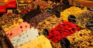 Colorful spices and teas displayed at a traditional market stall.