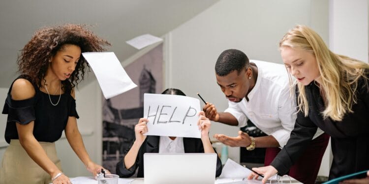 Team of stressed colleagues in an office dealing with paperwork chaos, asking for help.