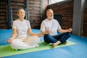 Senior couple engaged in meditation, enjoying a peaceful and healthy lifestyle.