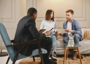 A counseling session with a diverse group of adults discussing issues in a cozy setting.