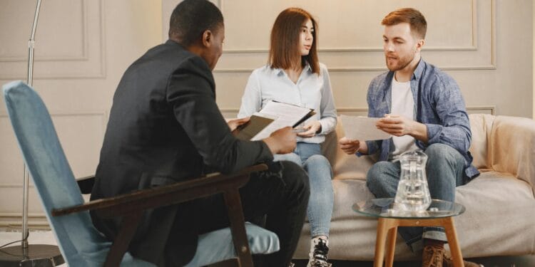 A counseling session with a diverse group of adults discussing issues in a cozy setting.