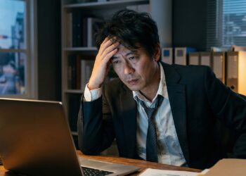 Professional pausing after work while beginning a burnout recovery plan.