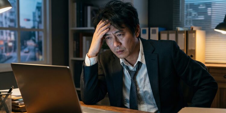 Professional pausing after work while beginning a burnout recovery plan.